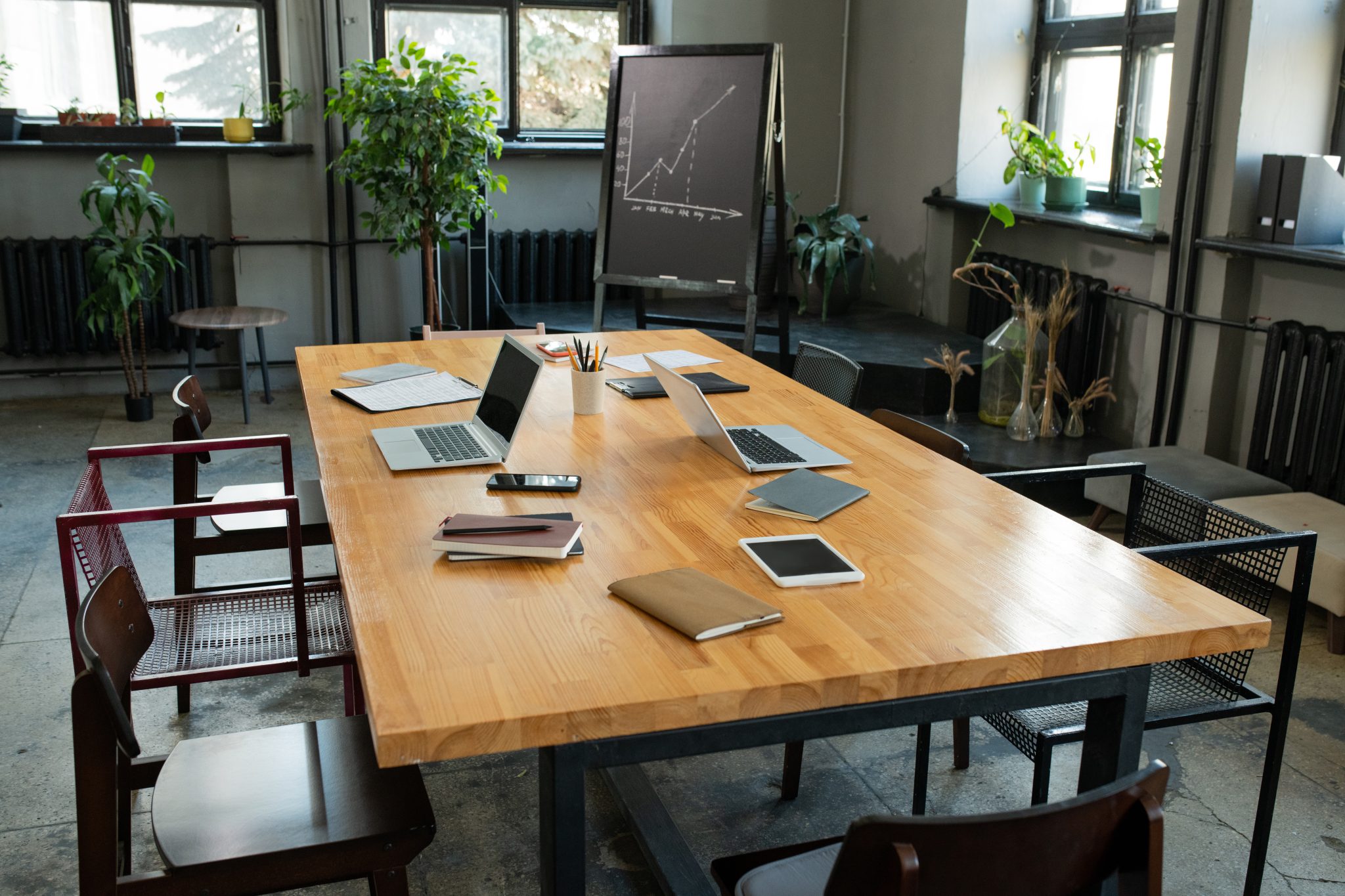 large table with business objects and group of chairs around it